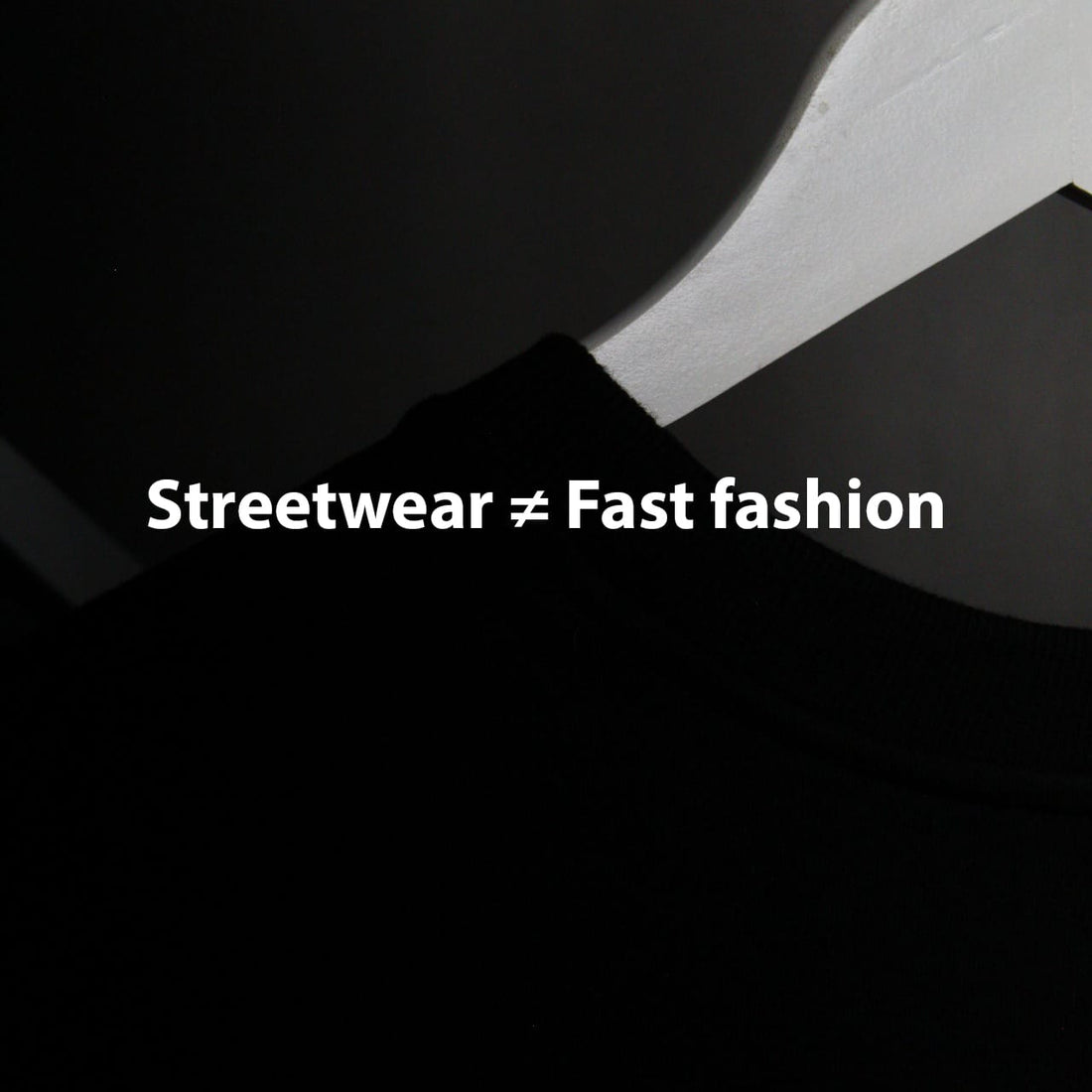 Minimalist graphic with white text "Streetwear ≠ Fast fashion" on a dark background, contrasting streetwear values against fast fashion.