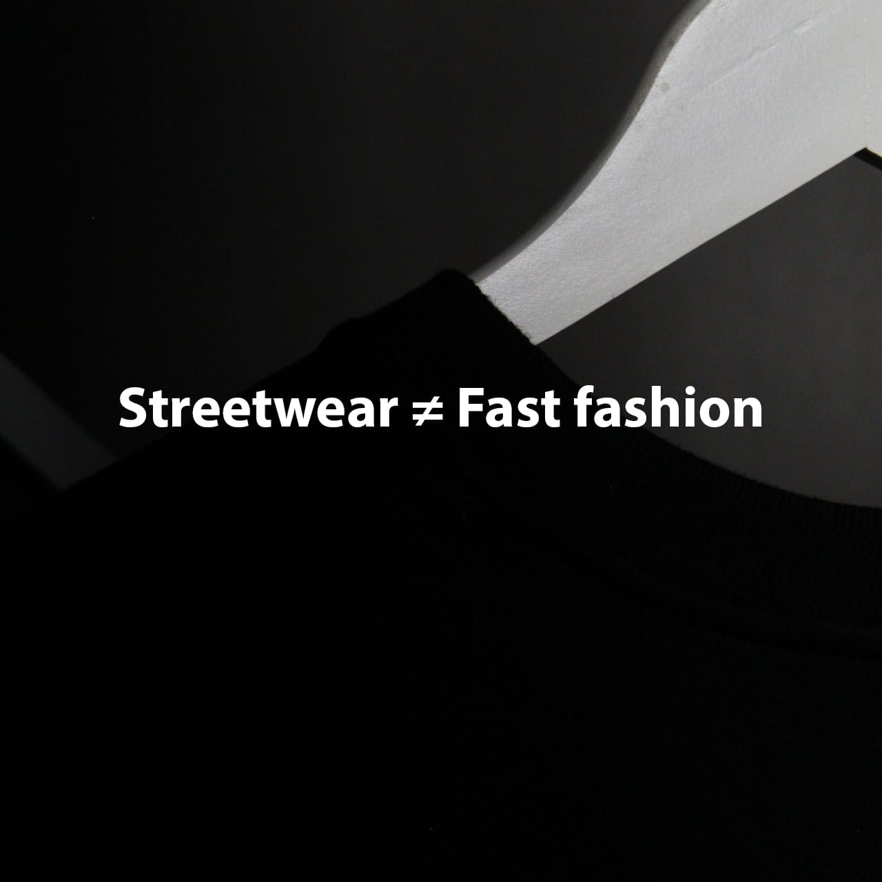 Minimalist graphic with white text "Streetwear ≠ Fast fashion" on a dark background, contrasting streetwear values against fast fashion.