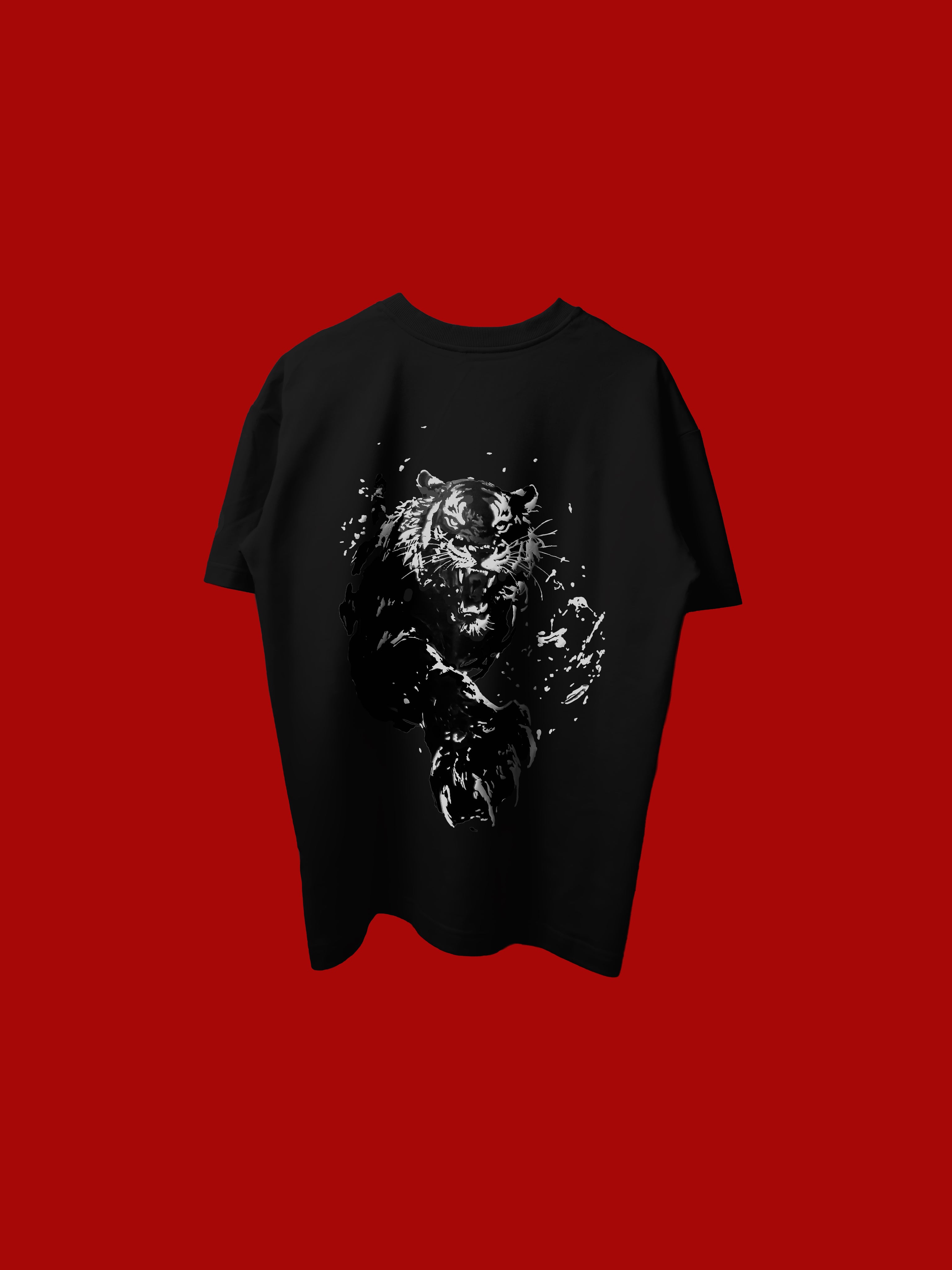 A black short-sleeve t-shirt with a white splattered graphic of a tiger on the back, displayed against a solid red background.