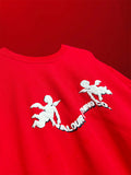 close-up detail of the vibrant red oversized t-shirt with white puff print cupid graphic and layered Valour Clothing Co text