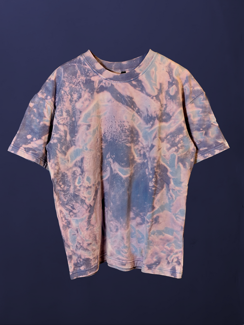 full front view of a purple and blue tonal acid wash oversized t-shirt, highlighting the unique bleach pattern and relaxed fit